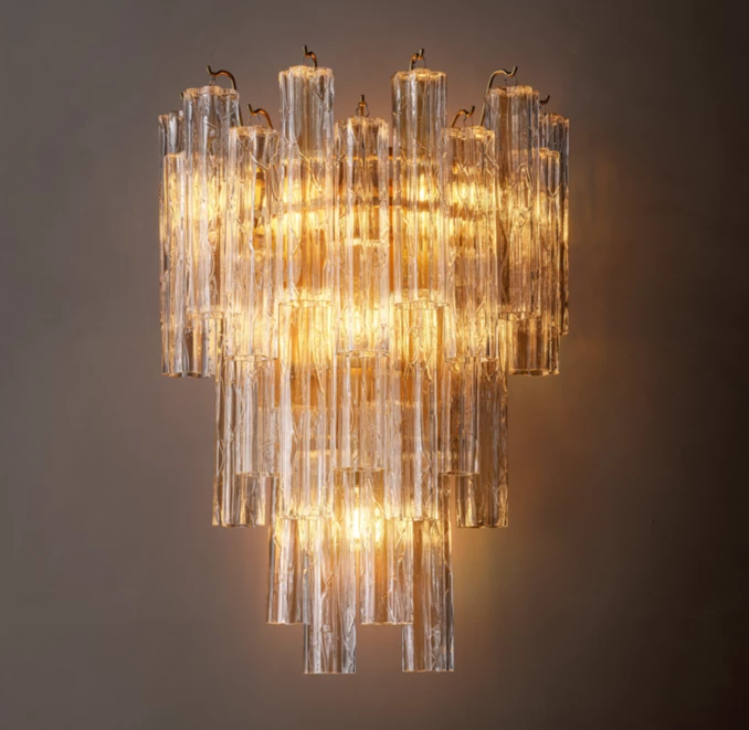 Elegant modern glass sconce with warm lighting for sophisticated interiors.