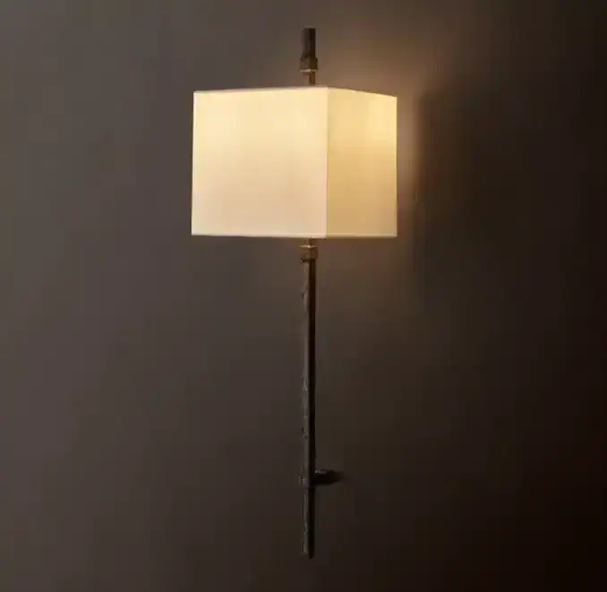 Elegant wall sconce with linen shade and brass finish for sophisticated lighting.