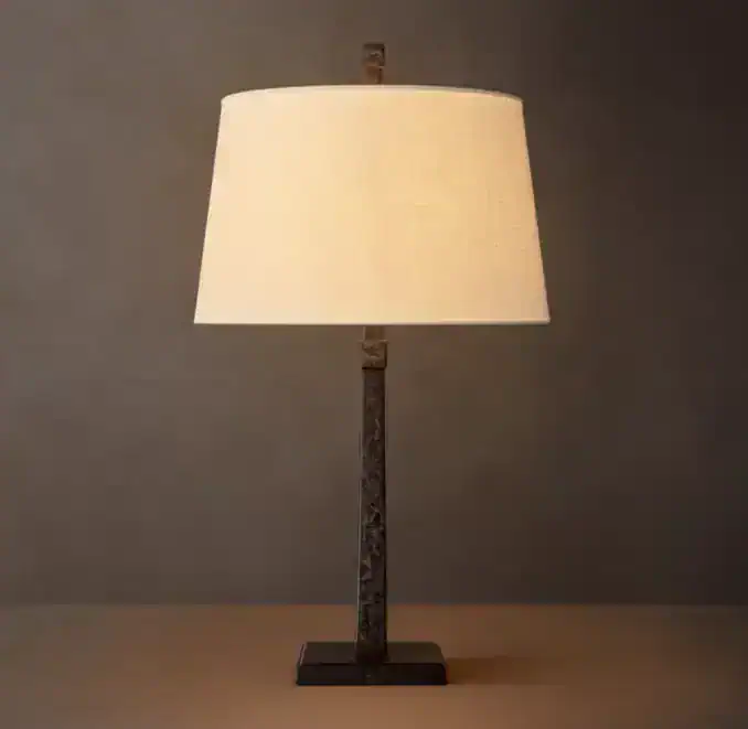 Modern table lamp with linen shade and metal base for home decor.