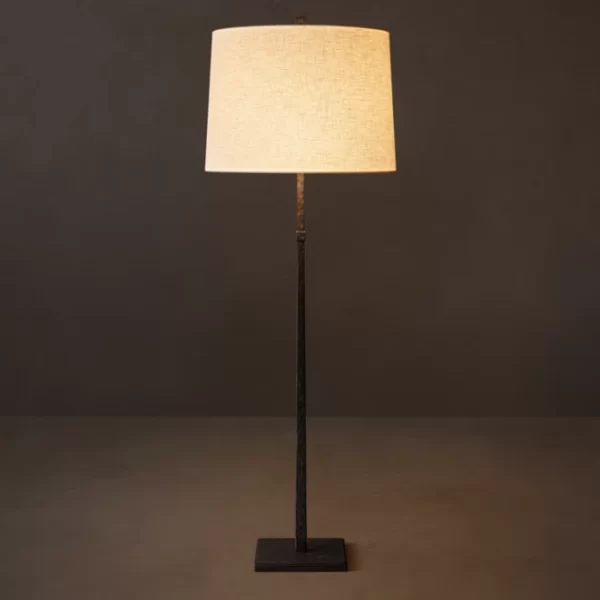 Elegant floor lamp with linen shade and black aluminum stand for modern decor.