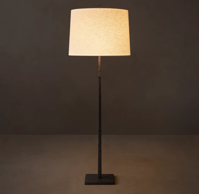 Elegant floor lamp with linen shade and black aluminum stand for modern decor.