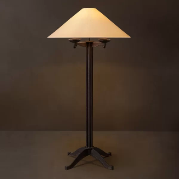 Rustic iron floor lamp with a beige lampshade for elegant lighting.