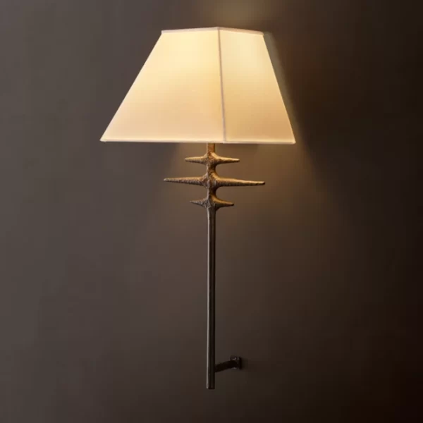 Modern metal sconce with a branch-like design and beige lampshade.