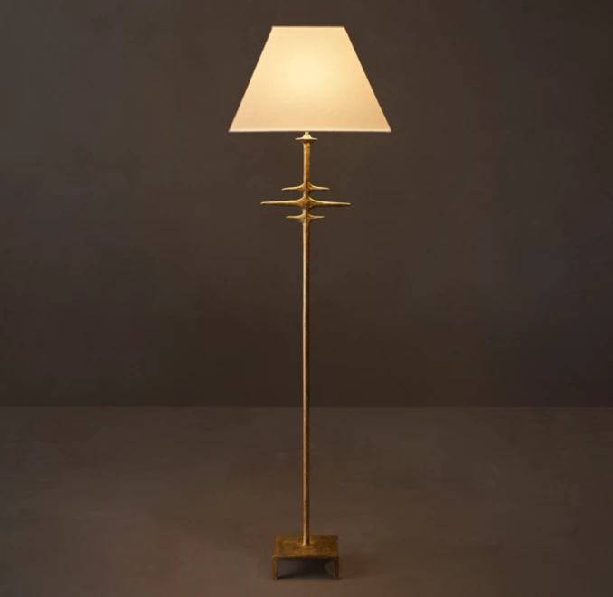 Modern metal floor lamp with linen shade for stylish lighting.
