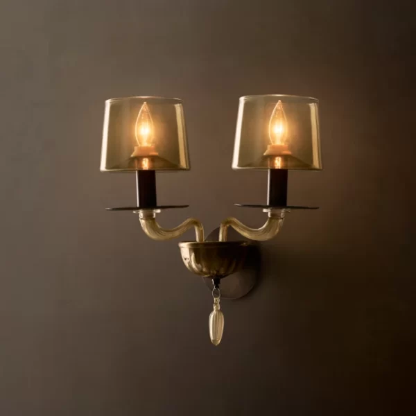 Elegant double wall sconce with glass shades and vintage bulbs for ambient lighting.