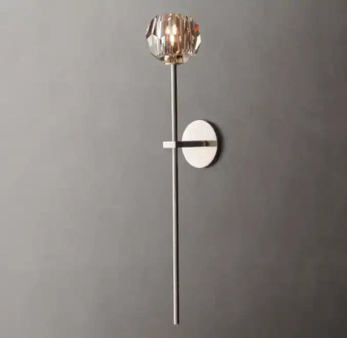 Elegant wall sconce with crystal and brass design for modern interiors.