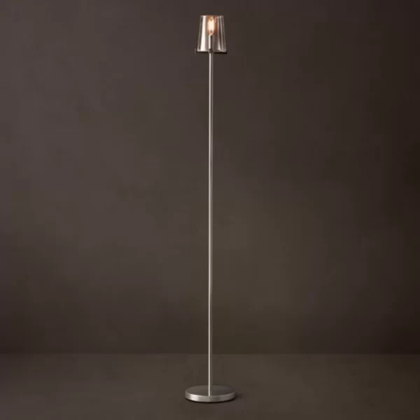 Modern floor lamp with a sleek metal stand and a glass shade for stylish lighting.