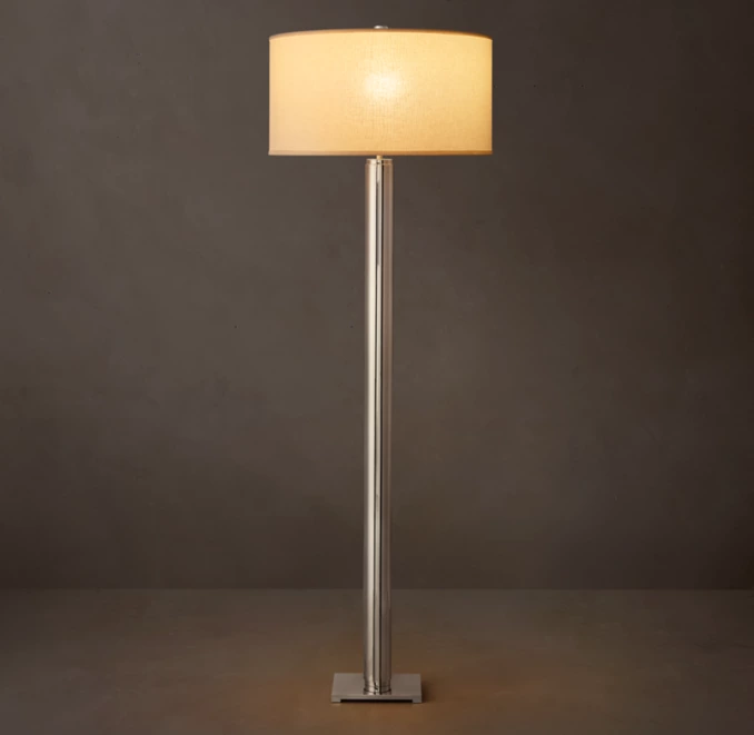 Modern floor lamp with a beige lampshade and sleek metal stand.