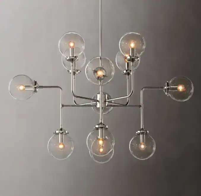 Contemporary chandelier with multiple glass globes and exposed bulbs.