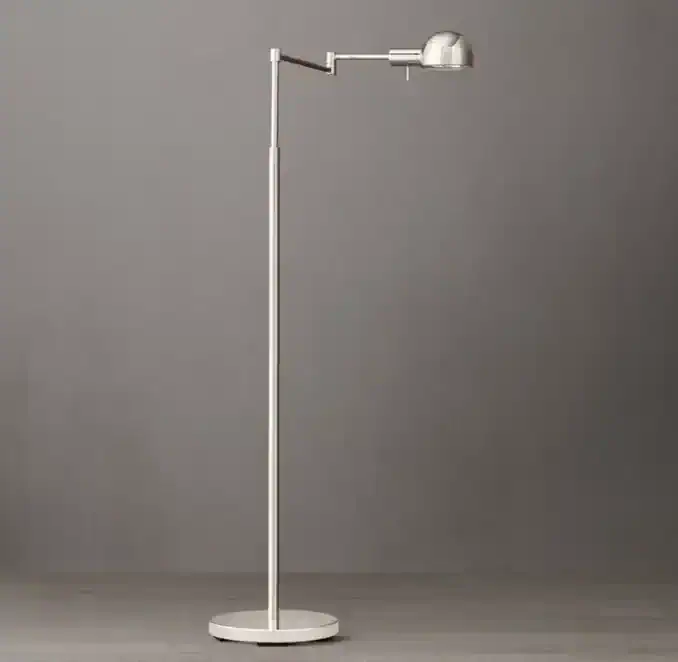 Modern metal task lamp with adjustable arm and dome shade for task lighting.