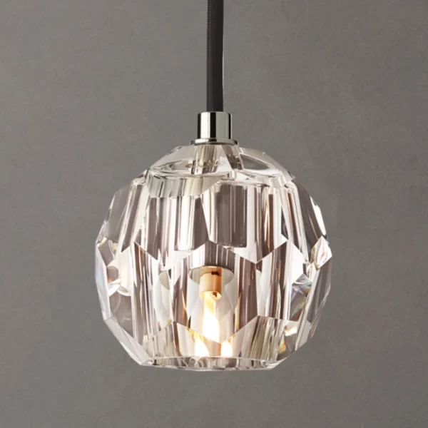 Elegant crystal pendant light with brass accents for modern interiors.